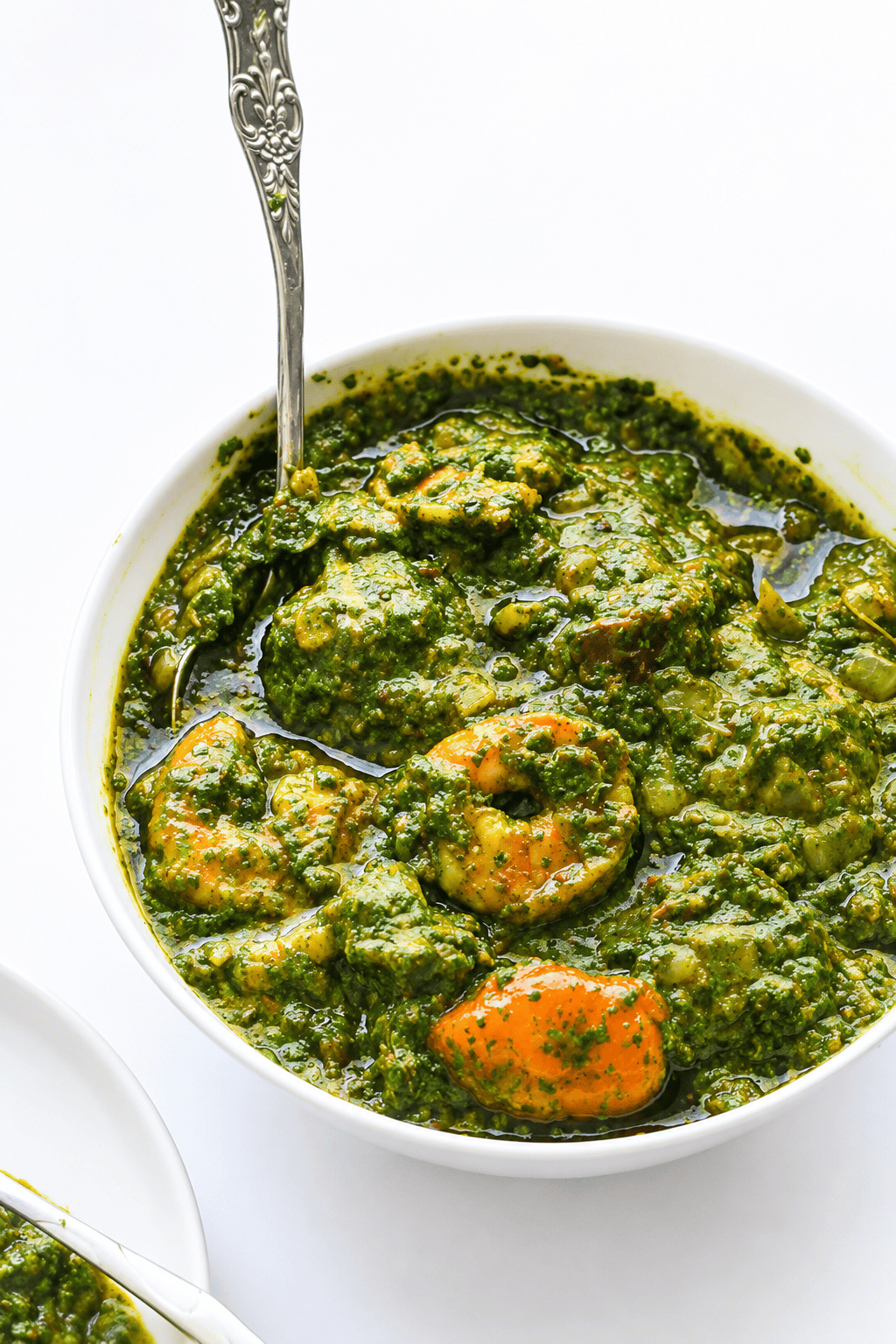 Spooning up freshly made and comforting cassava leaf soup.