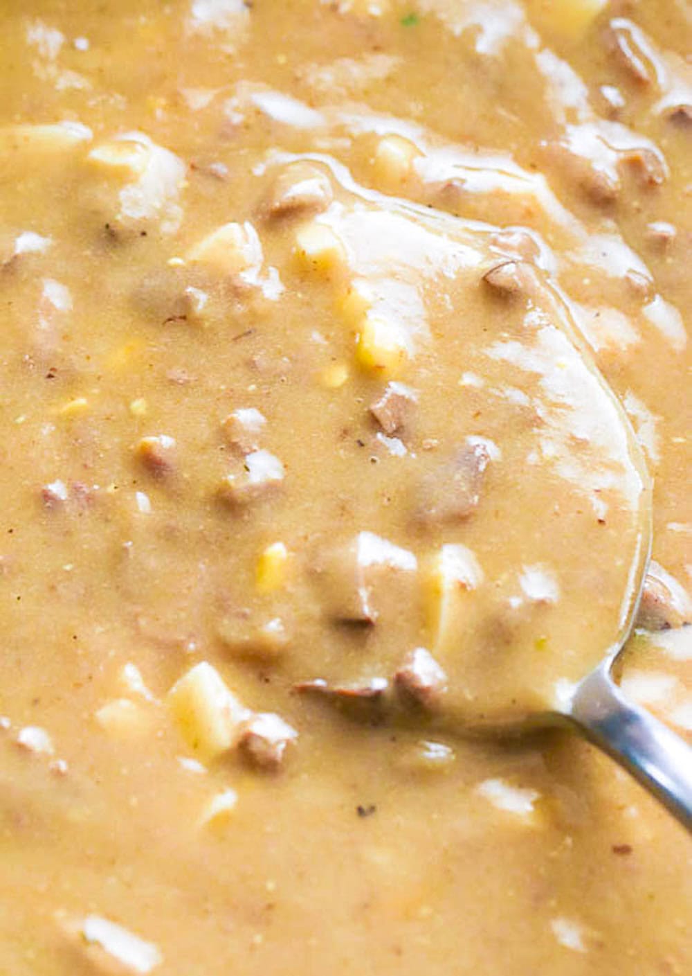 Stirring a skillet of deliciously thickened gravy made with giblets and pan drippings.