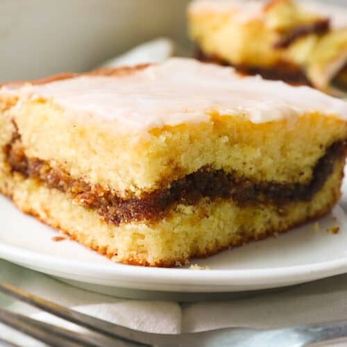Showing off a slice of honey bun cake with a cinnamon streusel layer. Pure yum!
