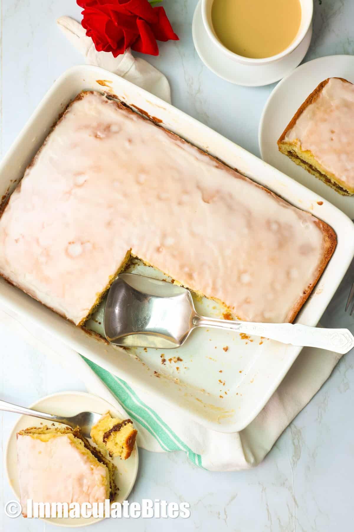 Cutting into a freshly baked cake, honey bun style, and enjoying it with a cup of coffee.