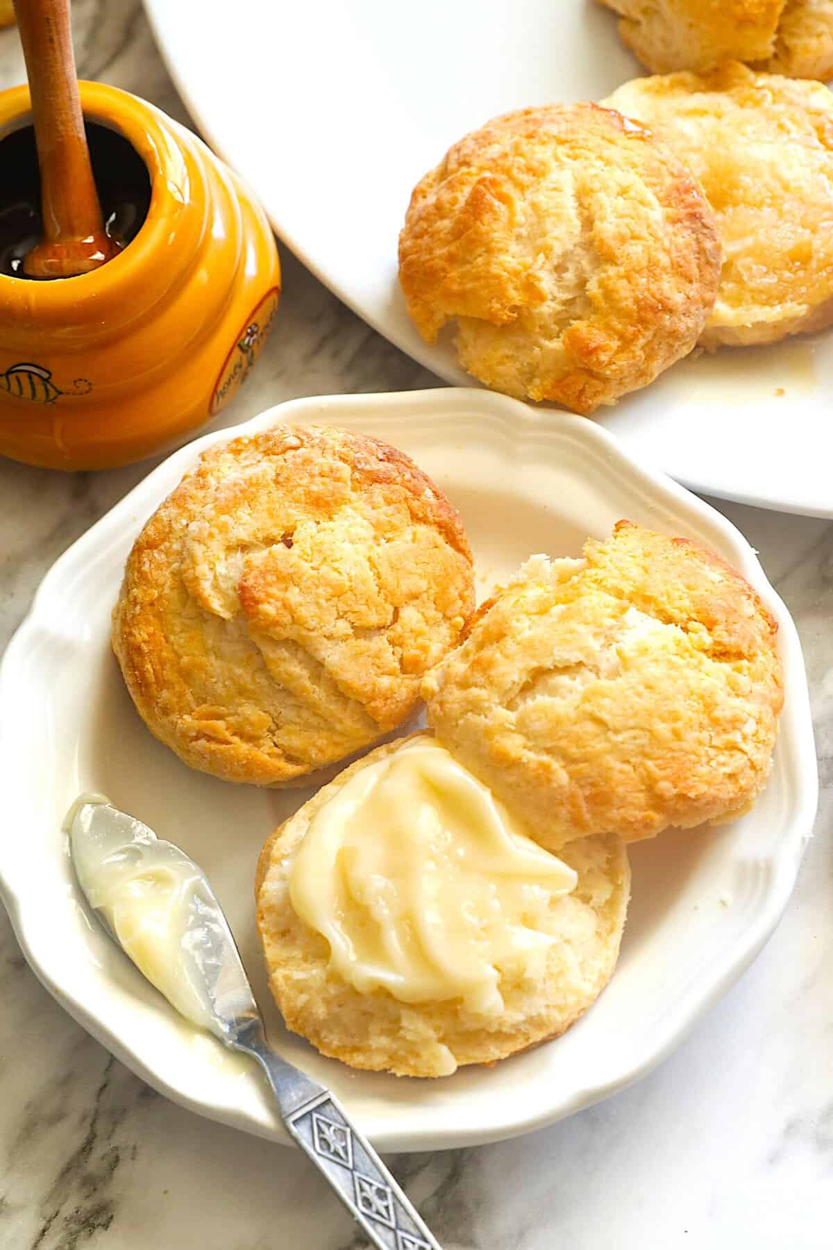 Slathering a freshly baked biscuit with honey butter for an amazing breakfast treat.