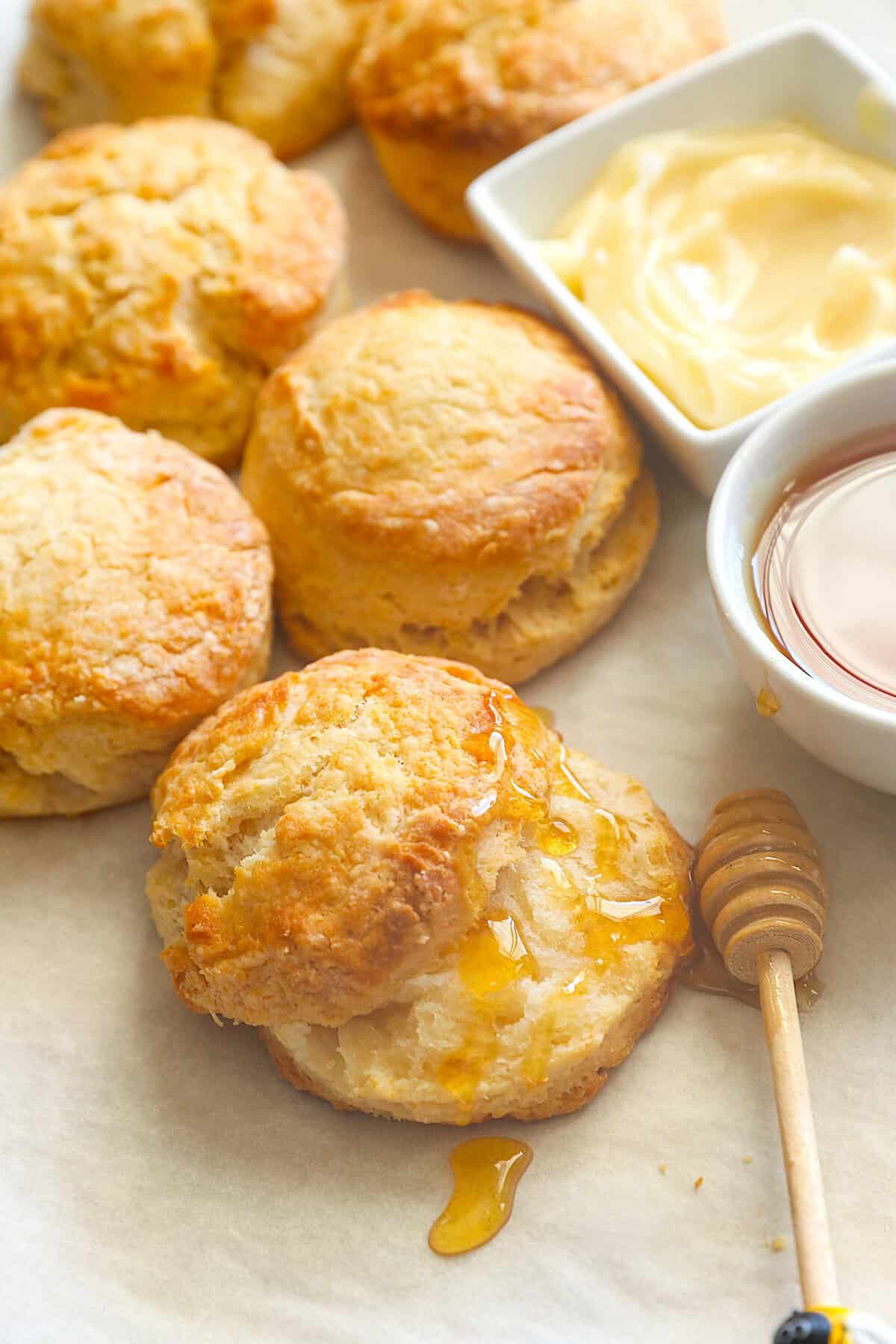 Slathering freshly baked biscuits with honey and butter for a great afternoon snack.