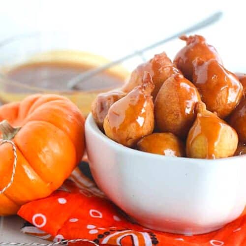 Freshly made pampoenkoekies, South African pumpkin fritters, drizzled with homemade caramel sauce for a decadent treat.