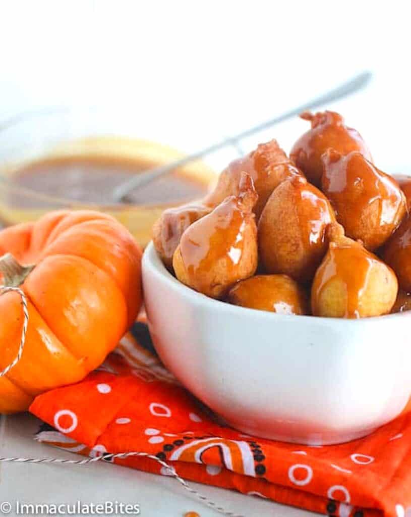 Freshly made pampoenkoekies, South African pumpkin fritters, drizzled with homemade caramel sauce for a decadent treat.