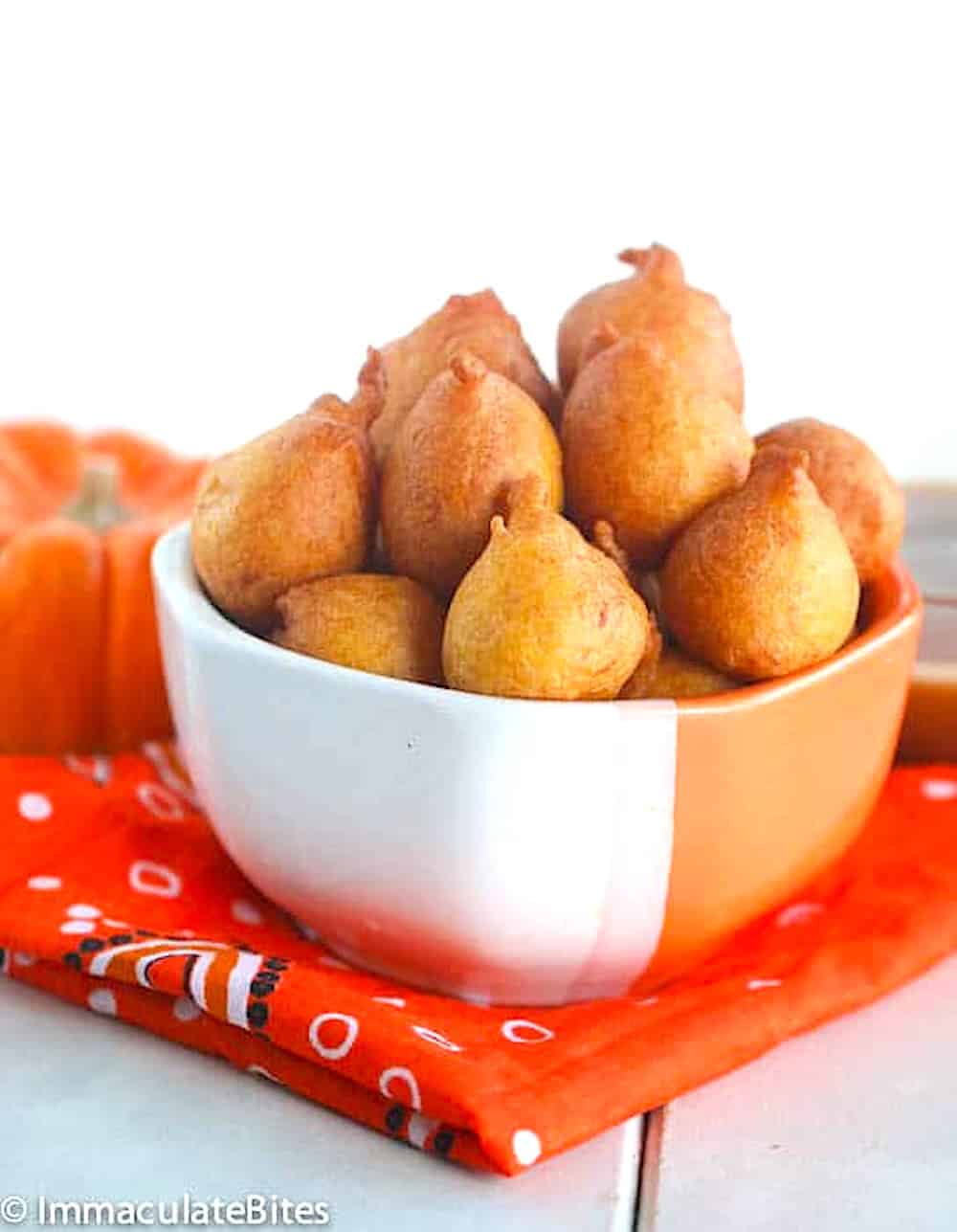 A bowl of freshly made South African pumpkin fritters, pampoenkoekies, ready to devour.