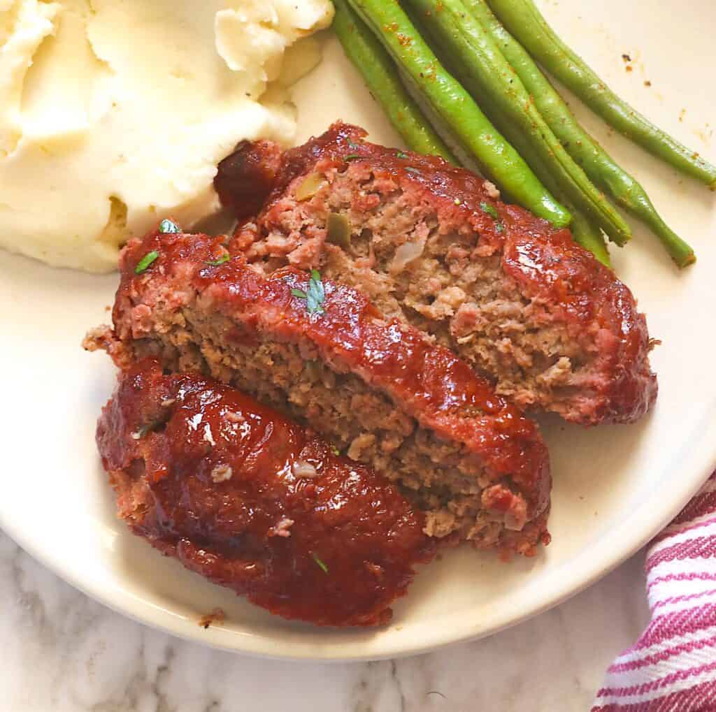 Glazed, smoked meatloaf with mashed potatoes and green beans for an elevated comfort food.