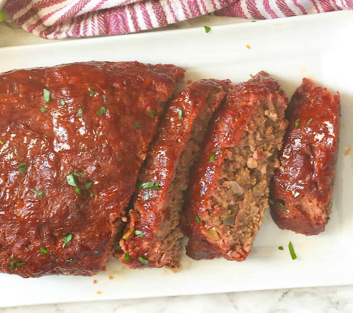 Slicing into a freshly smoked meatloaf for a satisfying comfort food meal.
