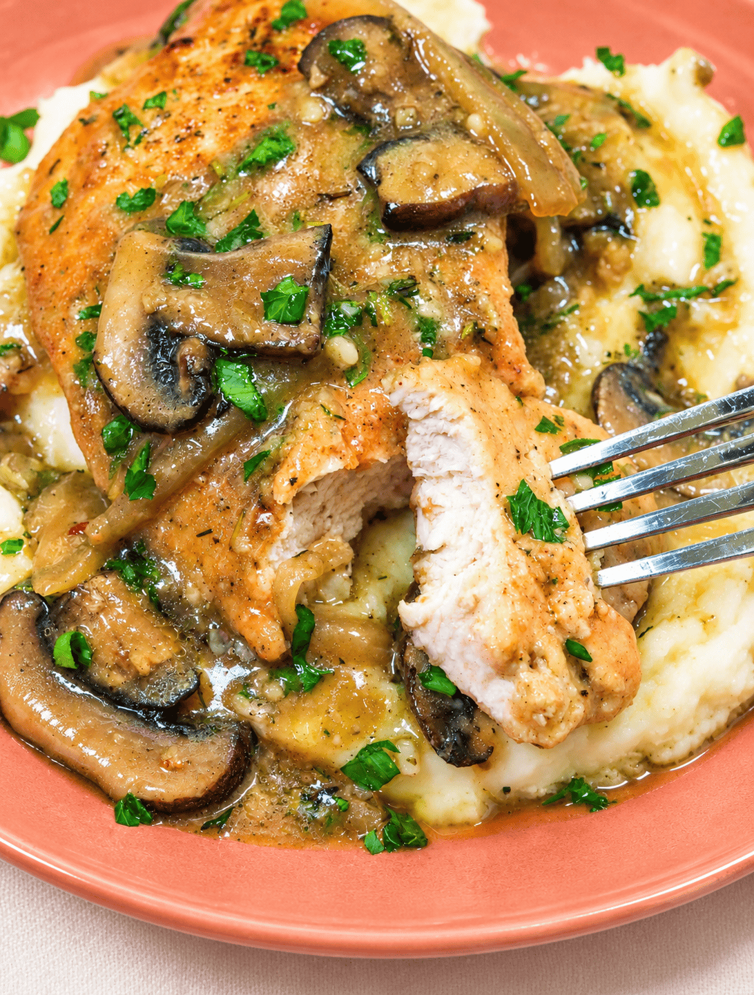 Forking into a tender, juicy turkey breast smothered in a mushroom gravy.