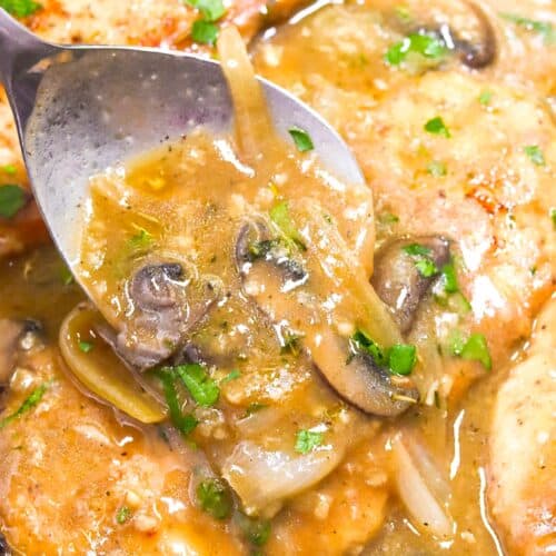 Spooning mushroom gravy over tender, smothered turkey chops.