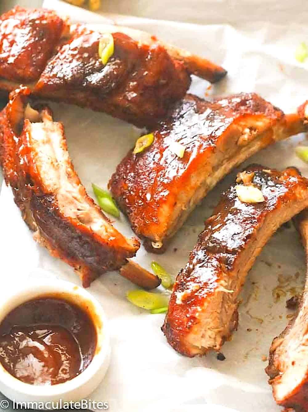 Baby back ribs sliced into appetizer size sections and ready to enjoy with homemade BBQ sauce.