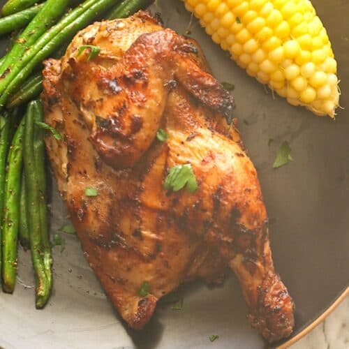 Serving up grilled Cornish hen with corn on the cob and green beans for an elegant dinner.