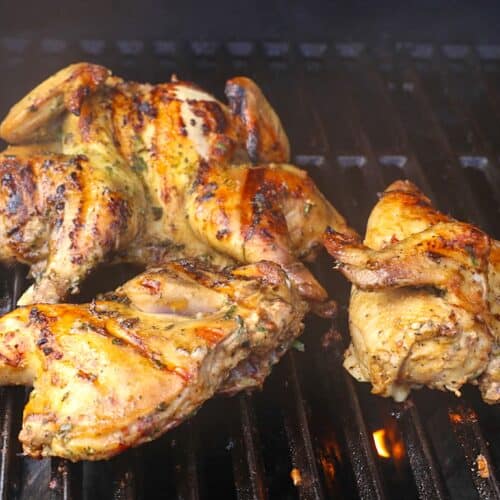Grilled Cornish hens ready to rest and serve. Ultra tender and juicy with delightfully crispy skin.