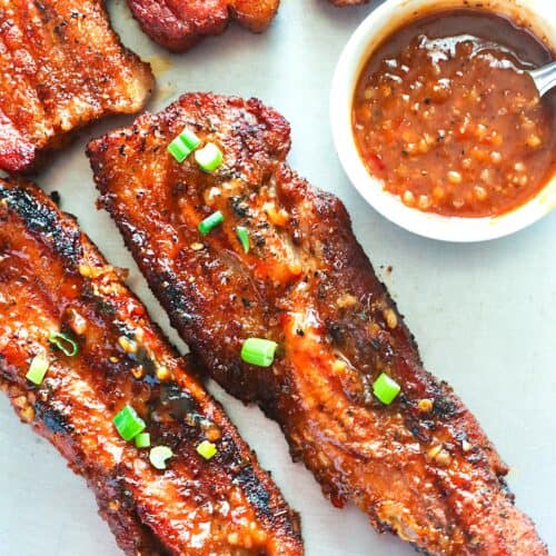 Freshly grilled pork belly ready to enjoy with a garlic chili sauce.