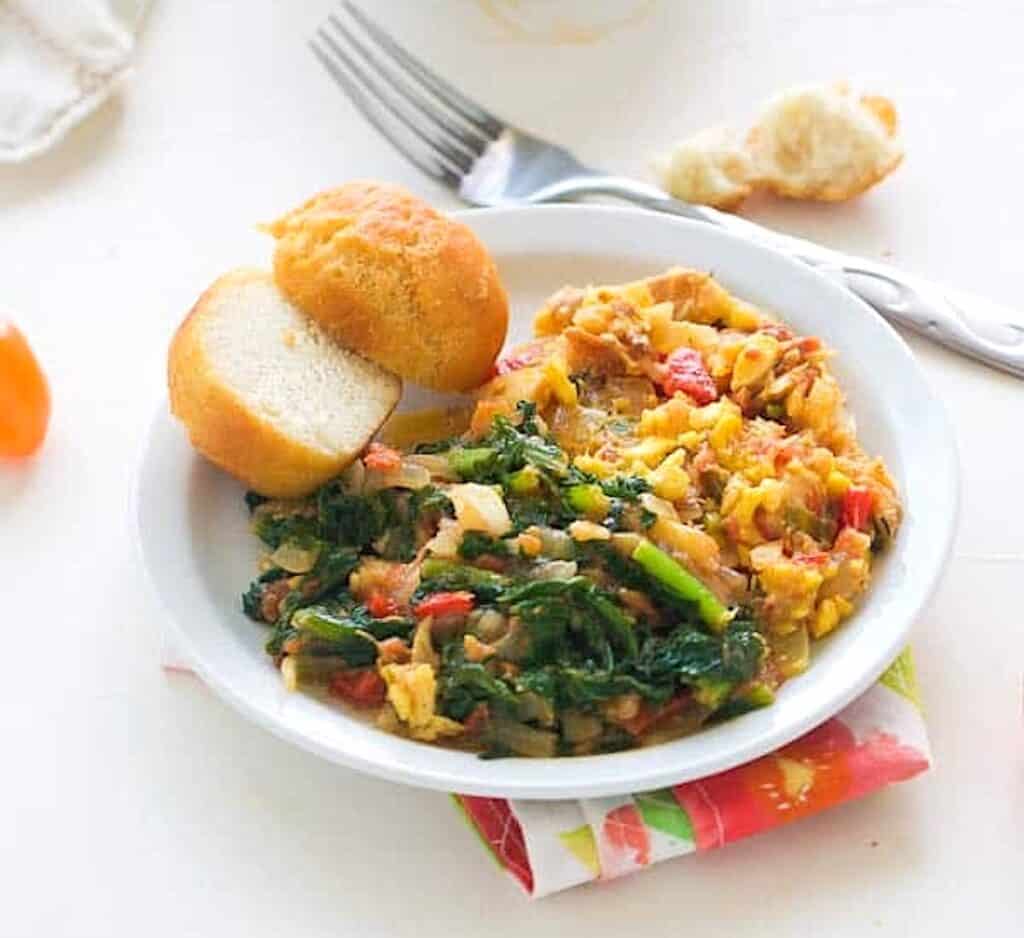 Enjoying Jamaican ackee and saltfish with callaloo and fried dumplings.