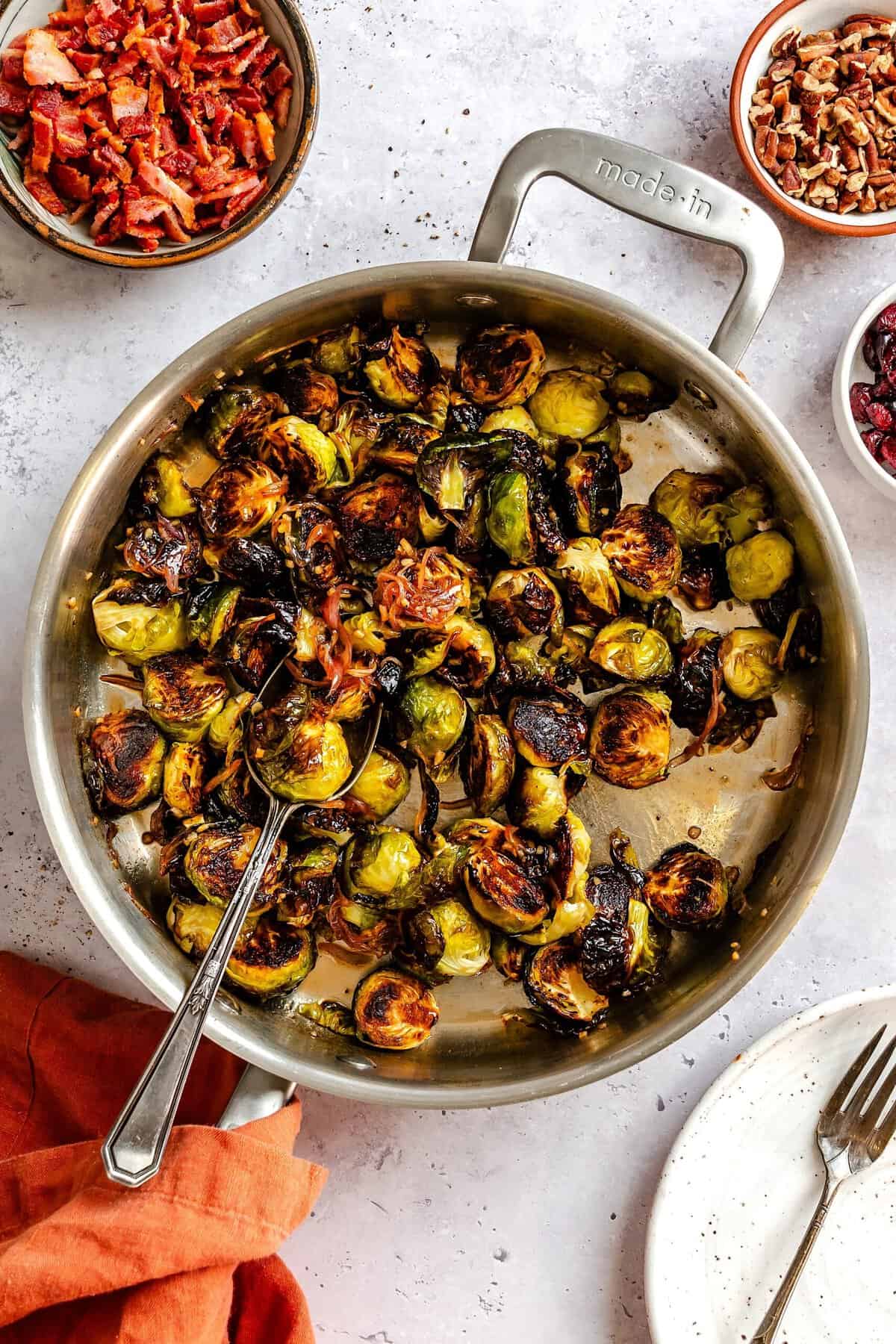 Finish loading the holiday glazed Brussels sprouts with the bacon, pecans, cranberries.