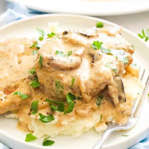 Serving tender pork chops with mushroom gravy over garlic mashed potatoes for a satisfying weeknight dinner.