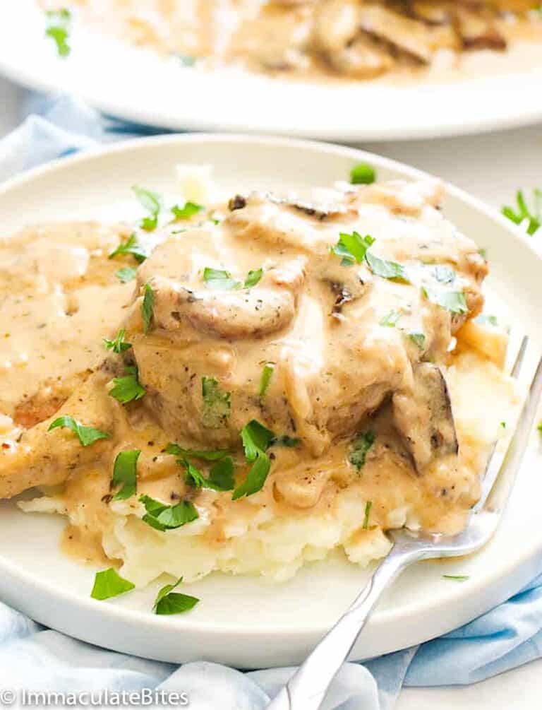Serving tender pork chops with mushroom gravy over garlic mashed potatoes for a satisfying weeknight dinner.